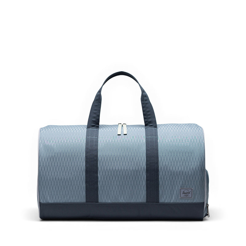 Blue duffel bag with black straps on a white background