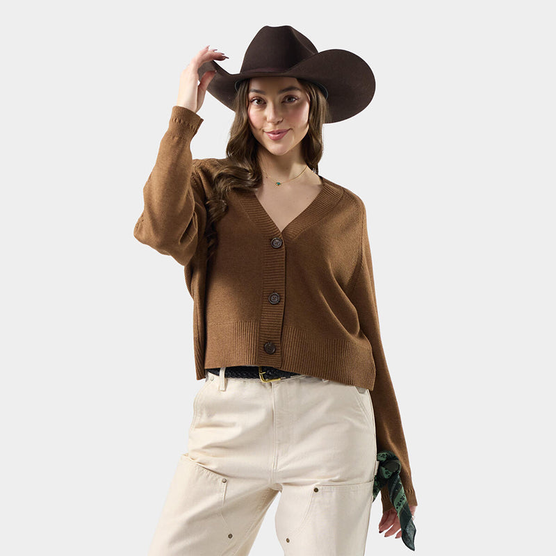 Woman wearing a brown cardigan and cowboy hat on a white background