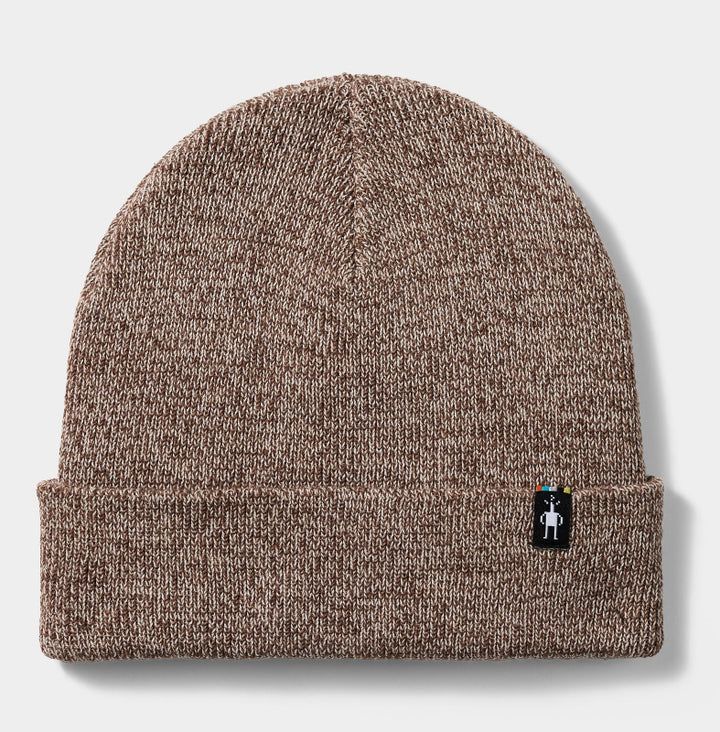A brown and beige heathered knit beanie hat with a folded cuff, featuring a small black and white logo patch on the side, set against a light gray background.