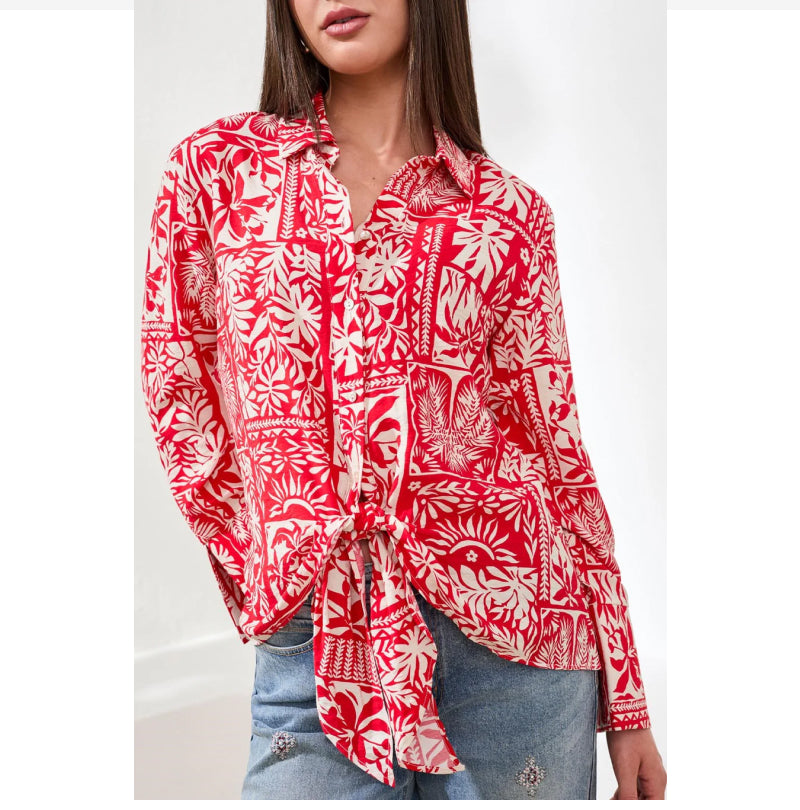 Woman wearing a red and white patterned shirt with a blurred background