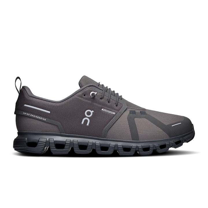 Gray running shoe with black sole on a white background