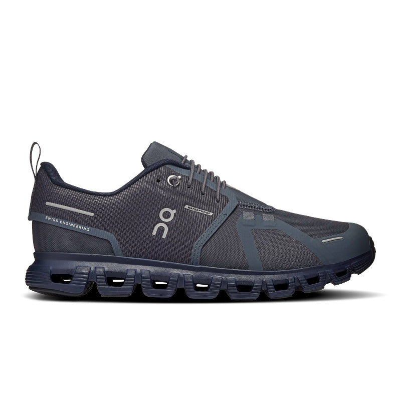 A dark gray and navy blue On running shoe with a distinctive cushioned sole, shown in a side profile on a white background.